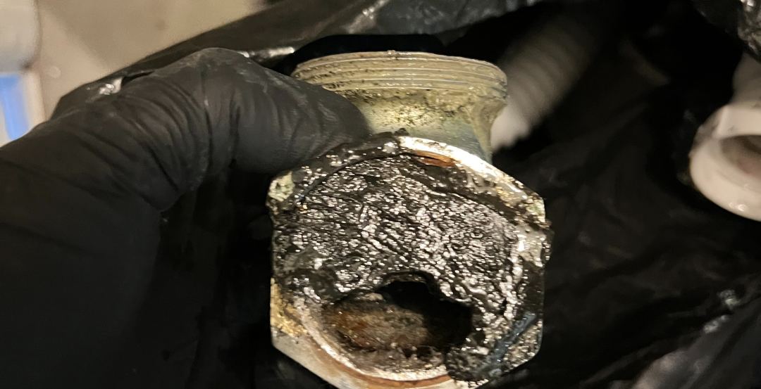 Heavy buildup removed from a drain cleanout by Best Coast Plumbing