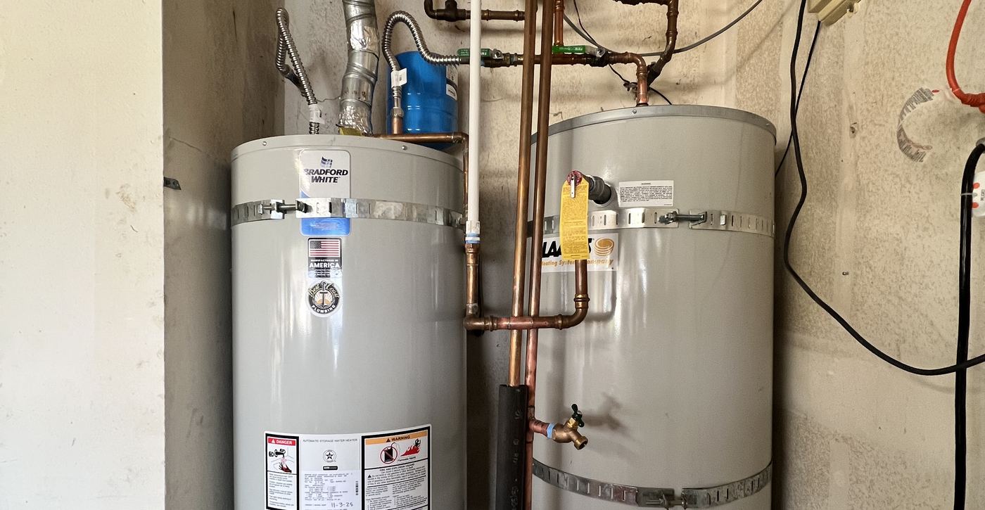 Two tank water heaters with new copper supply lines installed by Best Coast Plumbing