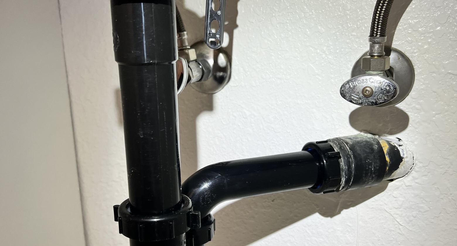 Under-sink drain trap and supply connections inspected during a Best Coast Plumbing visit