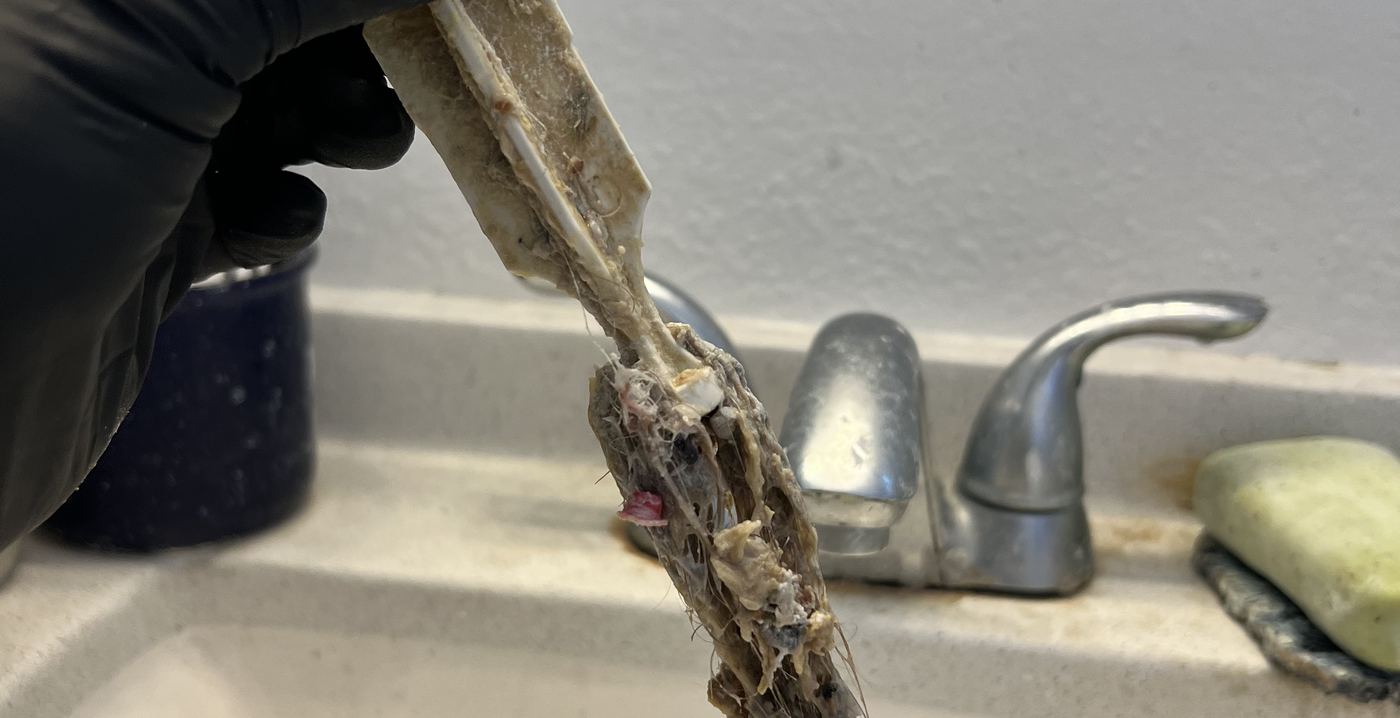 Best Coast Plumbing repairing a bathroom sink faucet during a service call