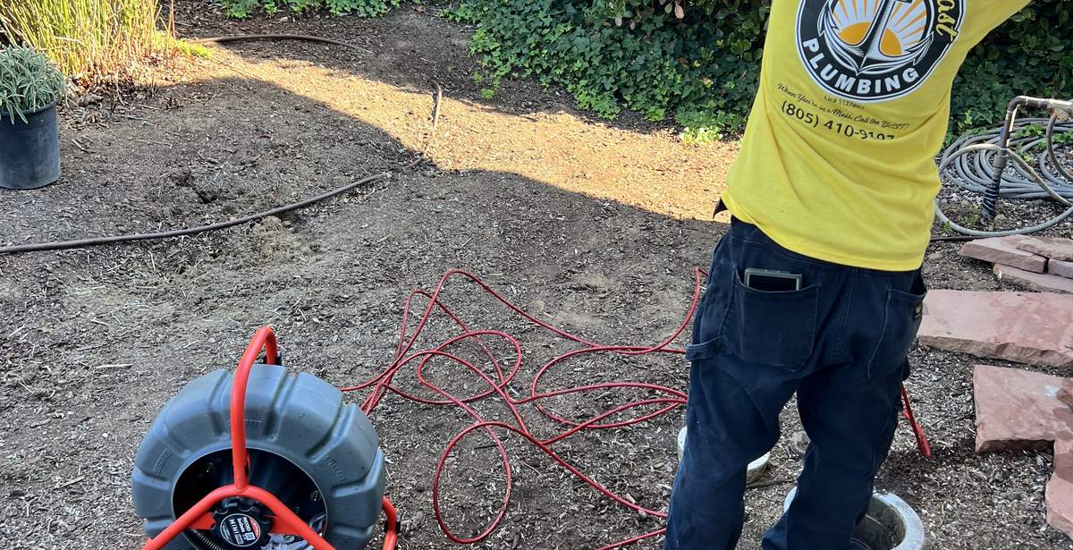 Best Coast Plumbing technician running a sewer camera inspection at a residence