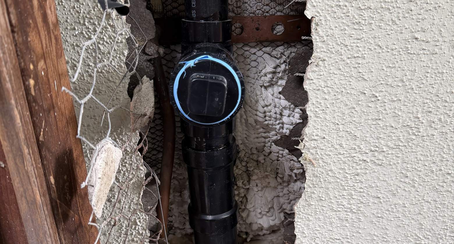 Pipe repair opened up inside a wall during a Best Coast Plumbing leak investigation