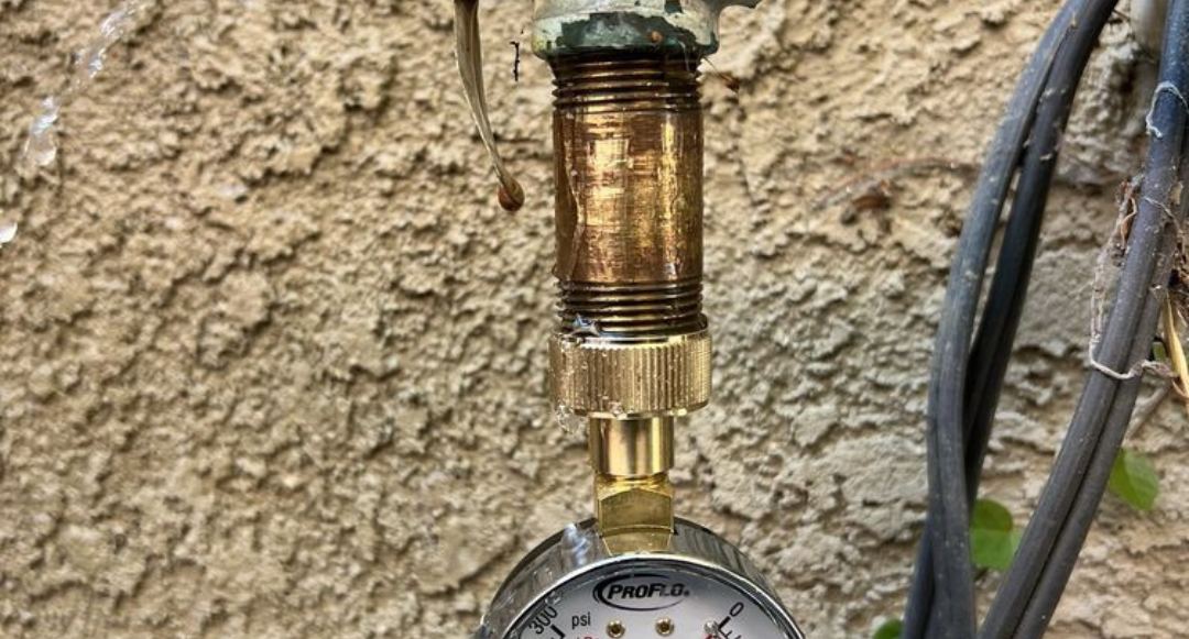 Water pressure gauge and regulator on a home water line tested by Best Coast Plumbing