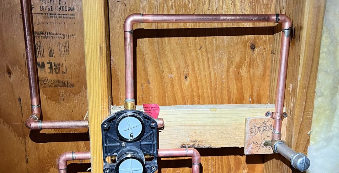New copper water lines installed in a wall by Best Coast Plumbing during a repipe