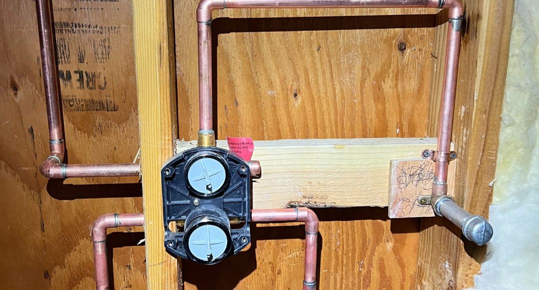 New copper supply lines and a shower valve roughed into open wall framing during a Best Coast Plumbing repipe