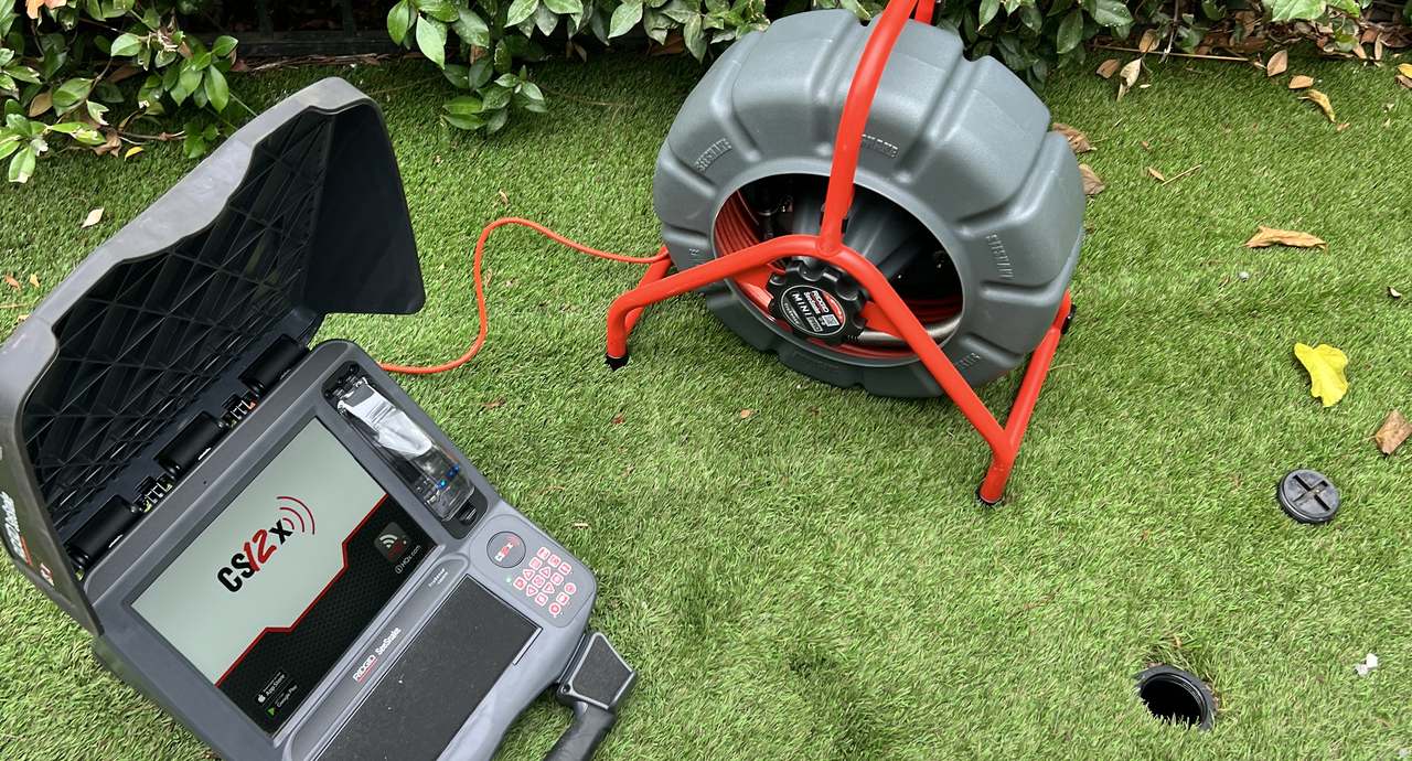 Best Coast Plumbing sewer camera equipment set up on a lawn for a sewer line inspection