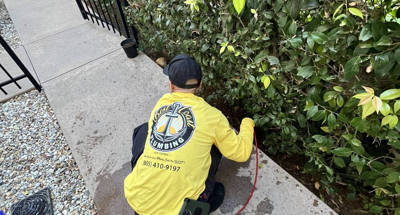 Best Coast Plumbing technician working at the exterior foundation line of a Southern California home