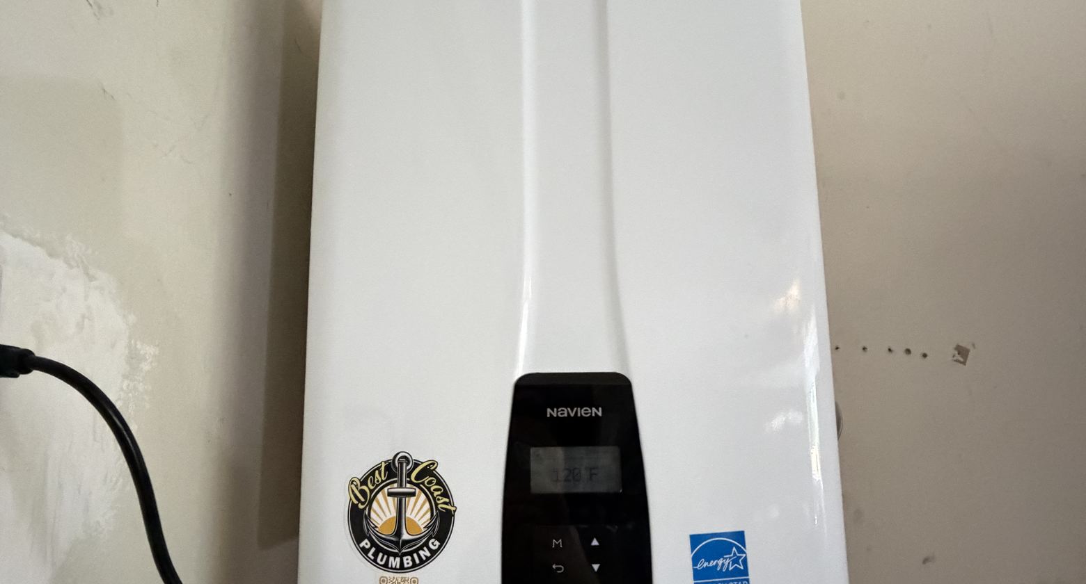 Wall-mounted tankless water heater installed by Best Coast Plumbing