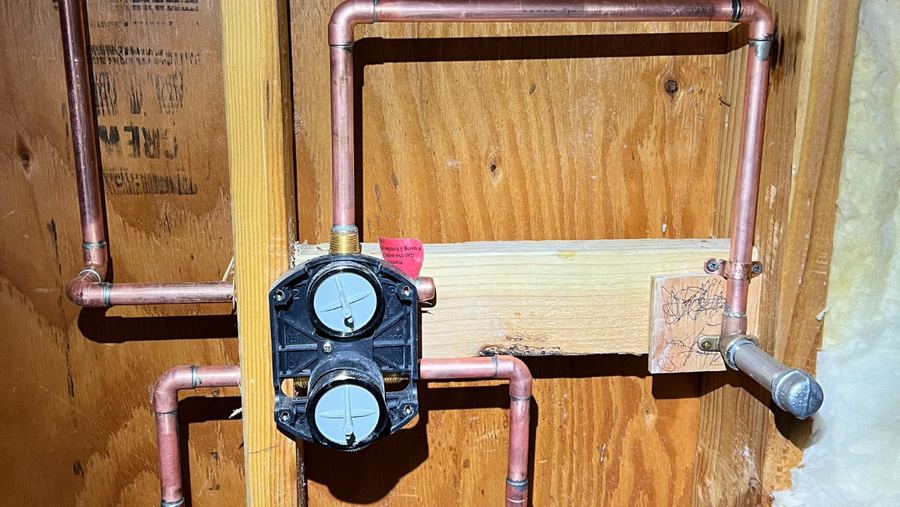 New copper supply lines roughed into open wall framing during a whole-house repipe