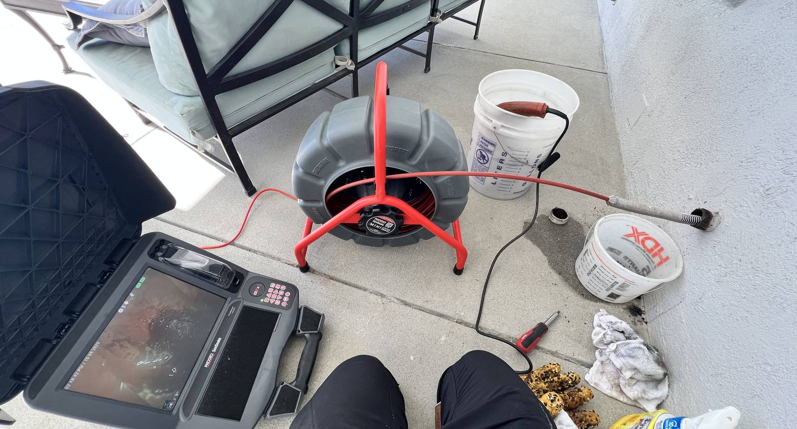 Best Coast Plumbing drain machine set up over an open cleanout during a service call