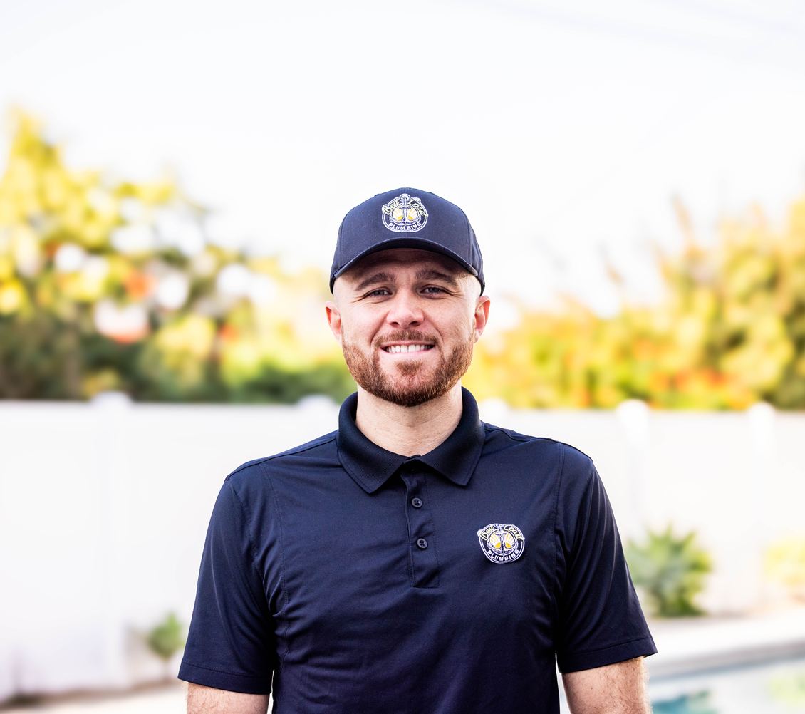 Brendan Lee, founder of Best Coast Plumbing, smiling in his branded uniform