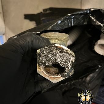 Scale-clogged drain fitting removed during a cleaning