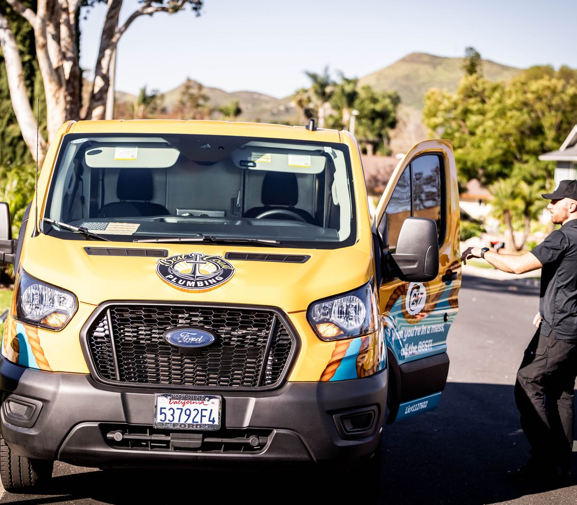 Best Coast Plumbing van arriving at a home on a residential street