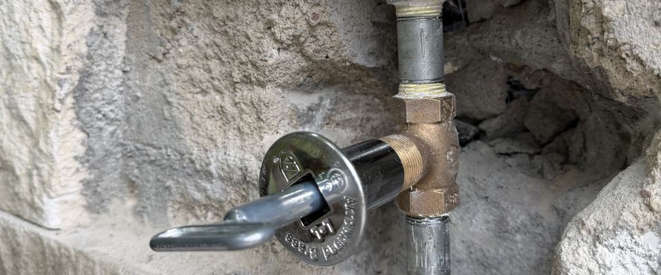 Fire pit gas key valve installed in a stone wall by Best Coast Plumbing